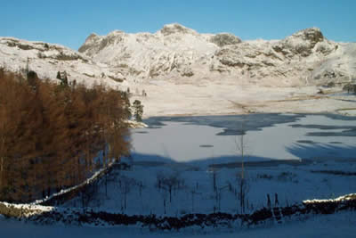 Looking across a frozen Blea Tarn to the Langdale Pikes