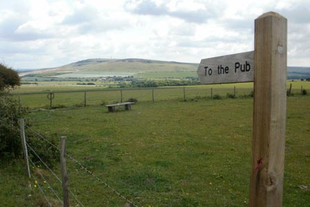 Sign indicating the way to the pub at Mill Hill