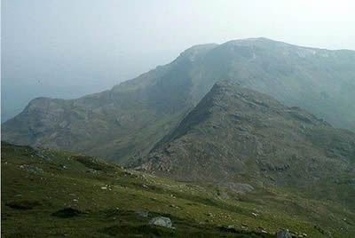 Rocky peak of Craigysgafn seen through summer haze