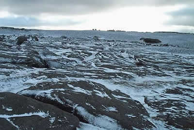 Snow disguises the peaty groughs on Kinder Scout