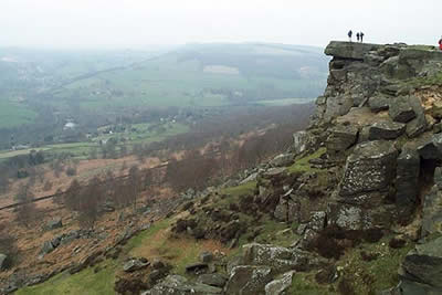 A group of walkers add scale to this view of Curbar Edge