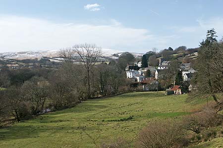 The village of Withypool with the high moors of Exmoor beyond