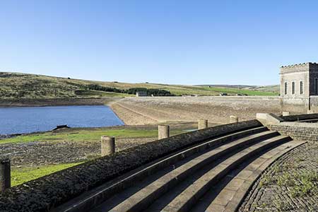 Dam and spillway at Burnhope Reservoir at time of low water