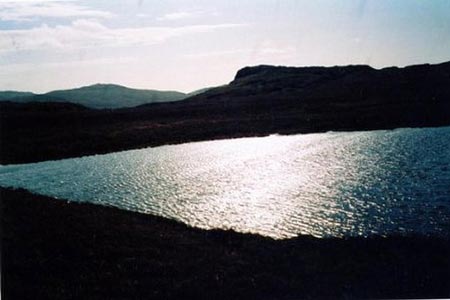 Low Birker Tarn sparkling in the afternoon sun