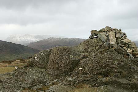 Cairn on Ivy Crag with the Langdale Pikes in the distance