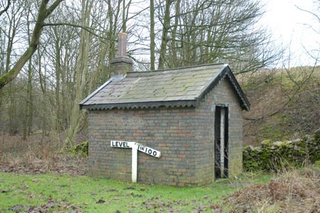 Brick hut & gradient post at old Hartington railway station