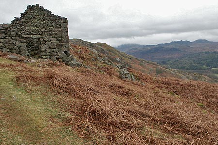 A derelict barn with Green Crag in the distance