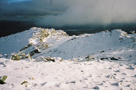 Looking towards Windermere from a snow-covered Bowfell