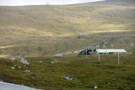 Gondola station and fence going up Aonach Mor
