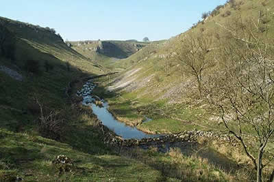 View west up Lathkill Dale from junction with Cales Dale
