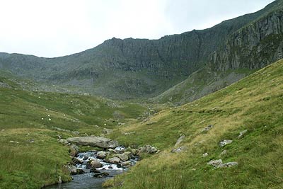 The crags of Ysgolion Duon rise over the Afon Lafar