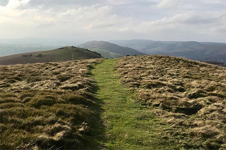 Looking back along the ridge from Willstone Hill with the Long Mynd in the mist