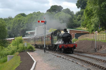 A steam hauled train enters Highley Station from the south
